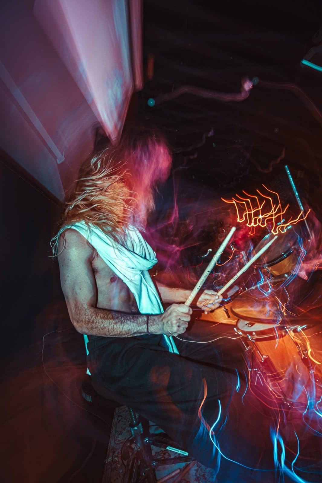 Drummer playing with motion blur and colourful stage lights at a Champions of Hope show