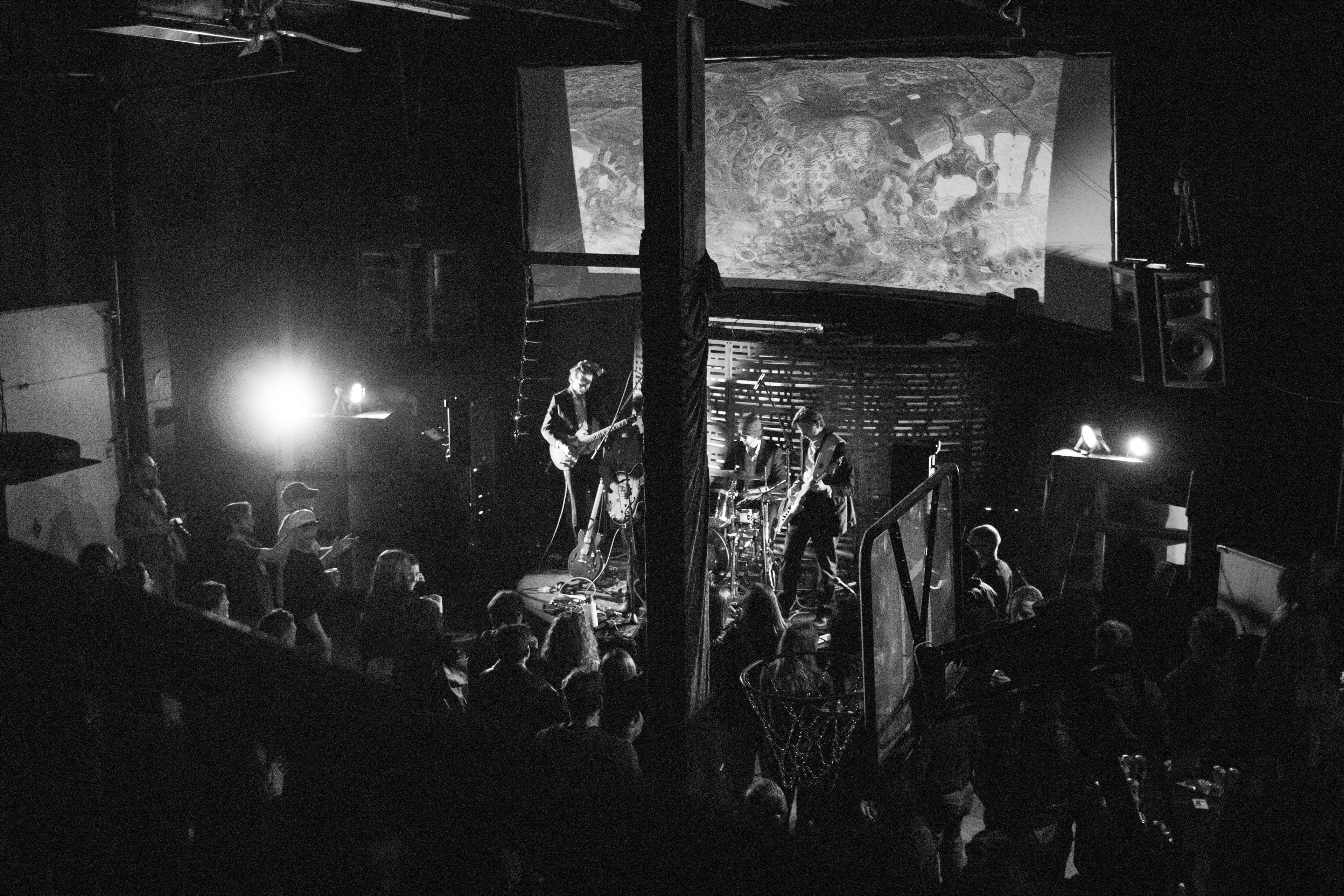 Wide black and white Champions of Hope concert crowd and band photo