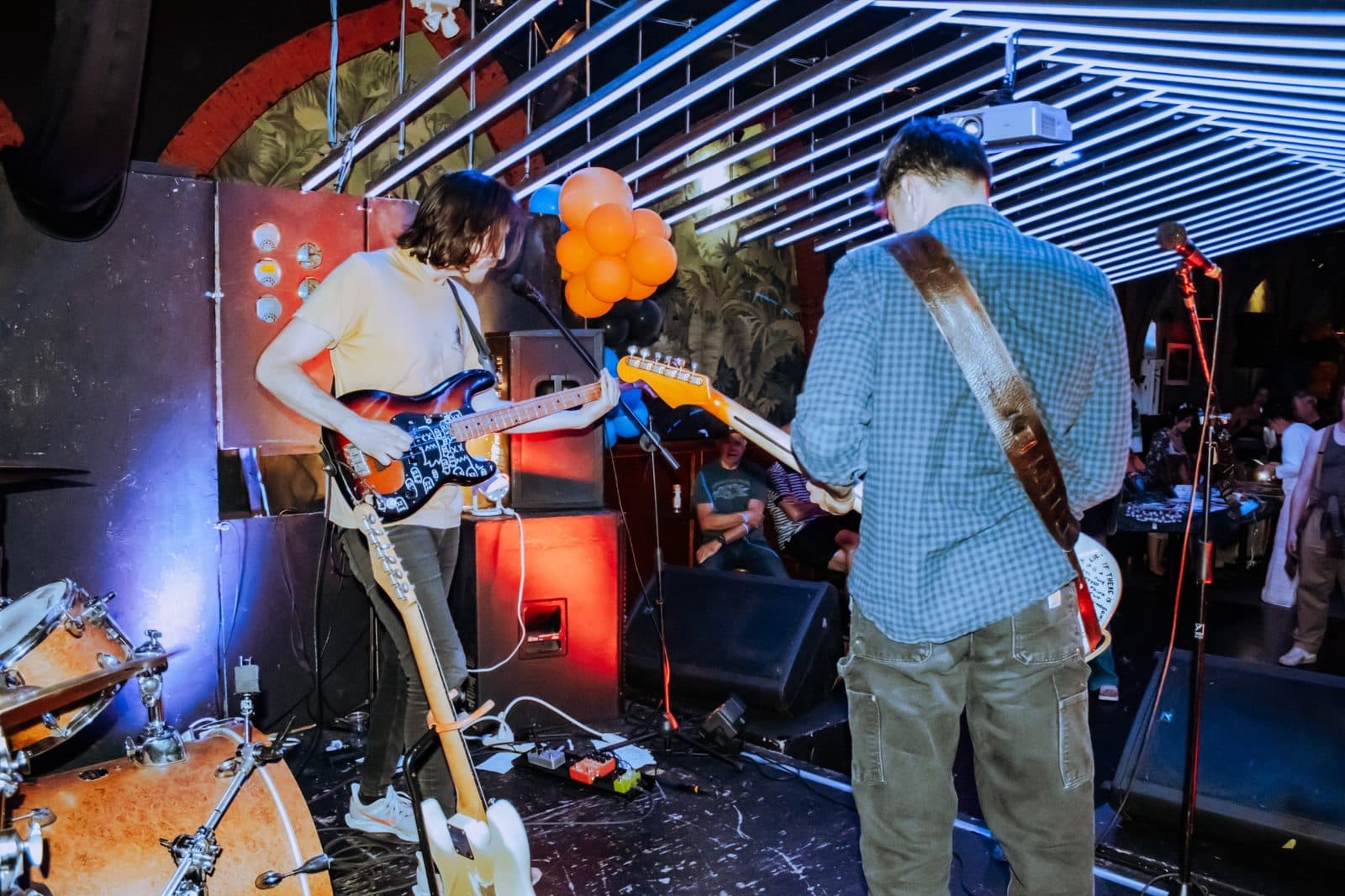 Guitarists performing on stage at a Champions of Hope show